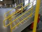Commercial safety railing with a bright yellow painted finish