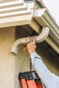 Gutter system attached along a residential roof edge
